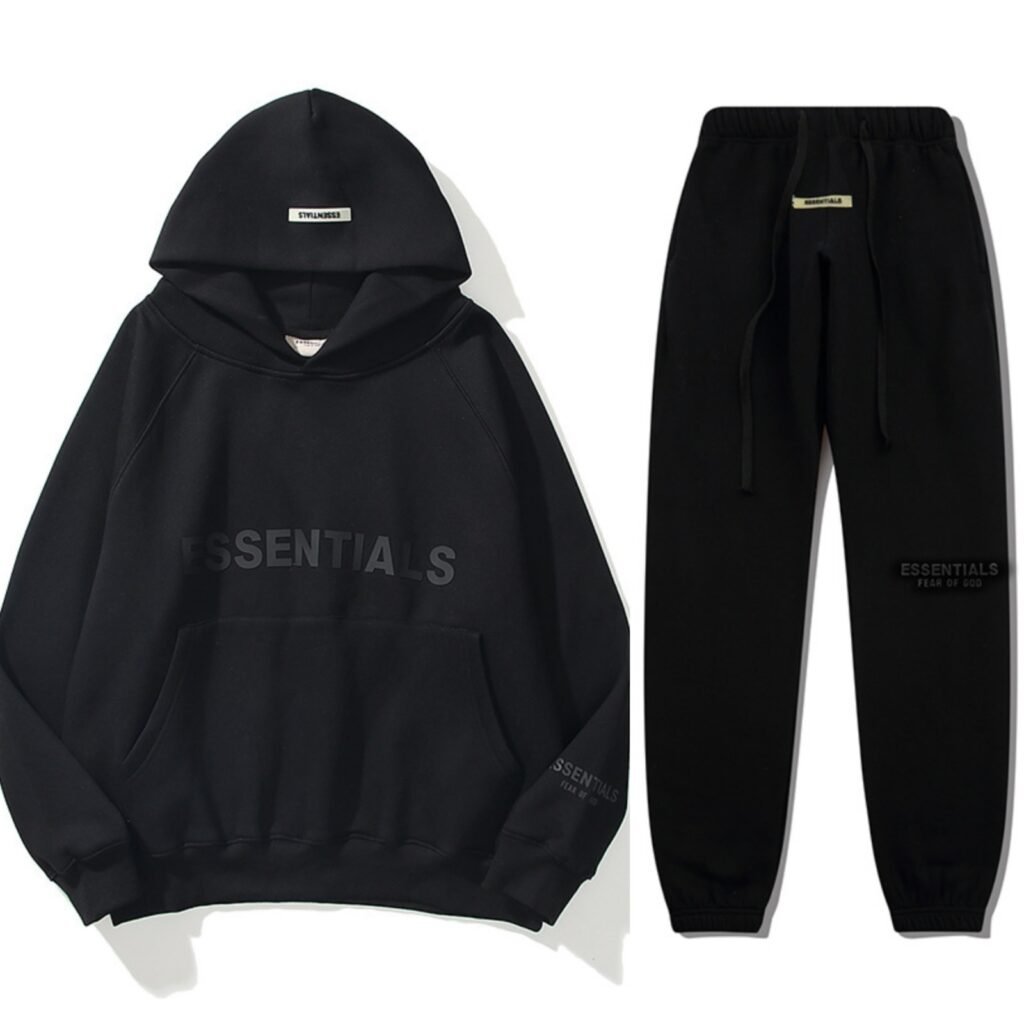 Essential Oversized Black Tracksuit Black oversized tracksuit set featuring the word "essentials" on both the sweatshirt and sweatpants. Black oversized tracksuit set featuring the word "essentials" on both the sweatshirt and sweatpants.